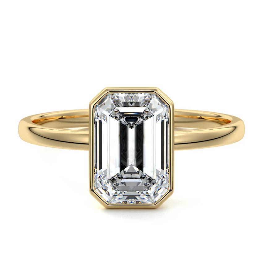 Bezel set emerald cut engagement ring in yellow gold with lab-grown diamond