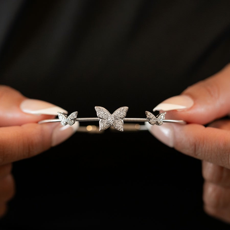 Close-up of butterfly diamond motif on flexible 14K white gold bangle