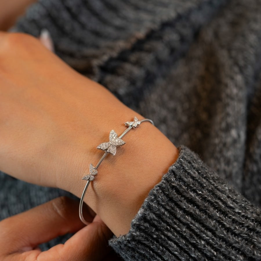 Stacked butterfly flex bangles in yellow and white gold, lab-grown diamonds