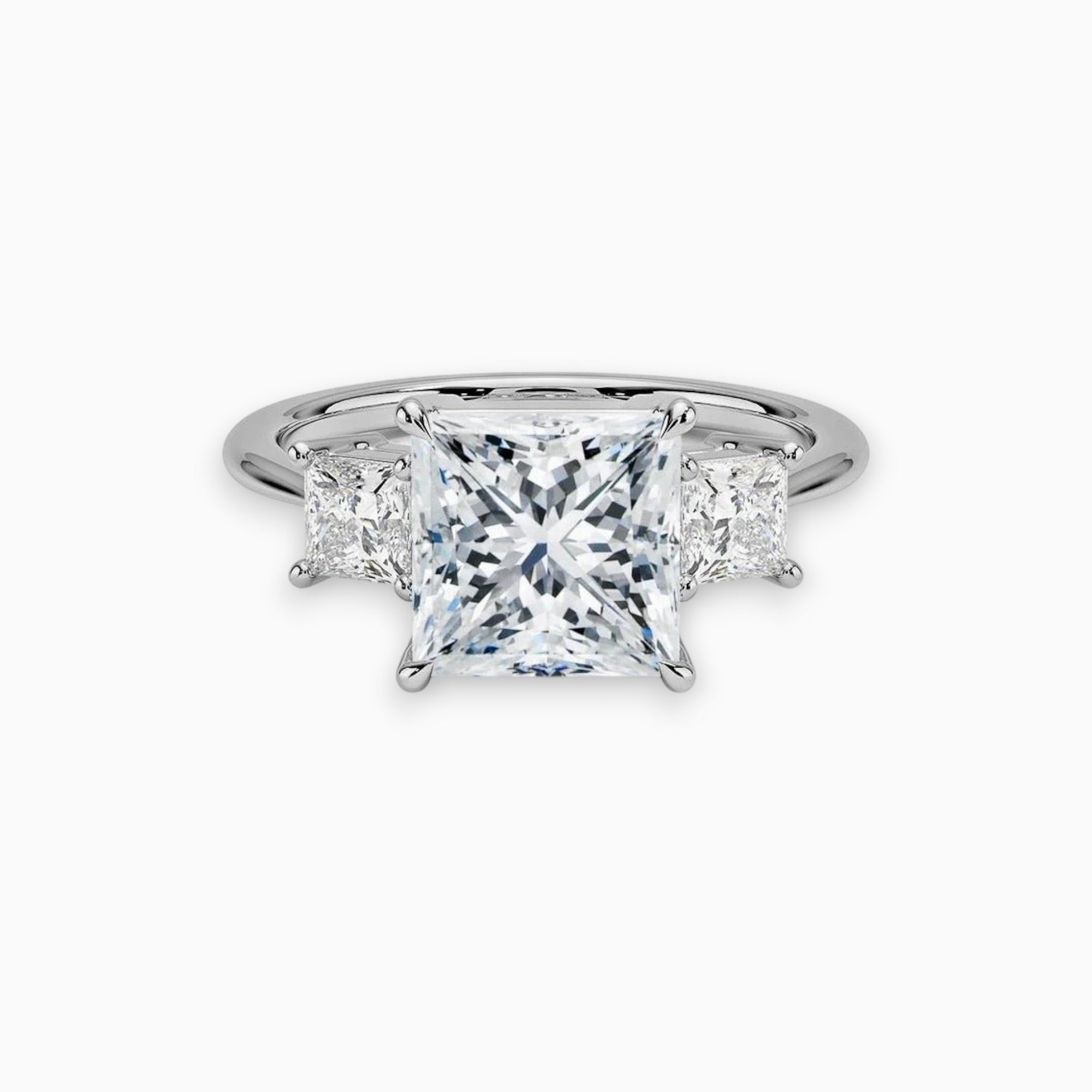 Three stone princess cut moissanite engagement ring in yellow, white, and rose gold or platinum, designed in New Zealand by Nura Lab.