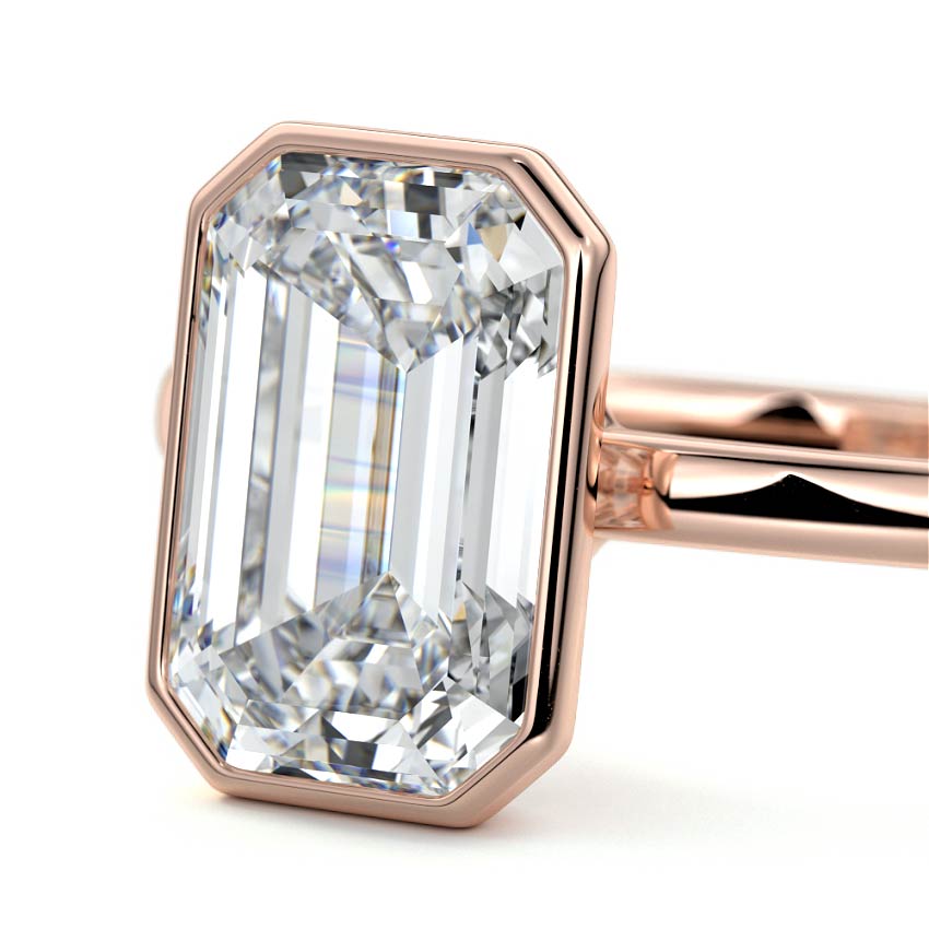 Bezel set emerald cut engagement ring in rose gold with lab-grown diamond