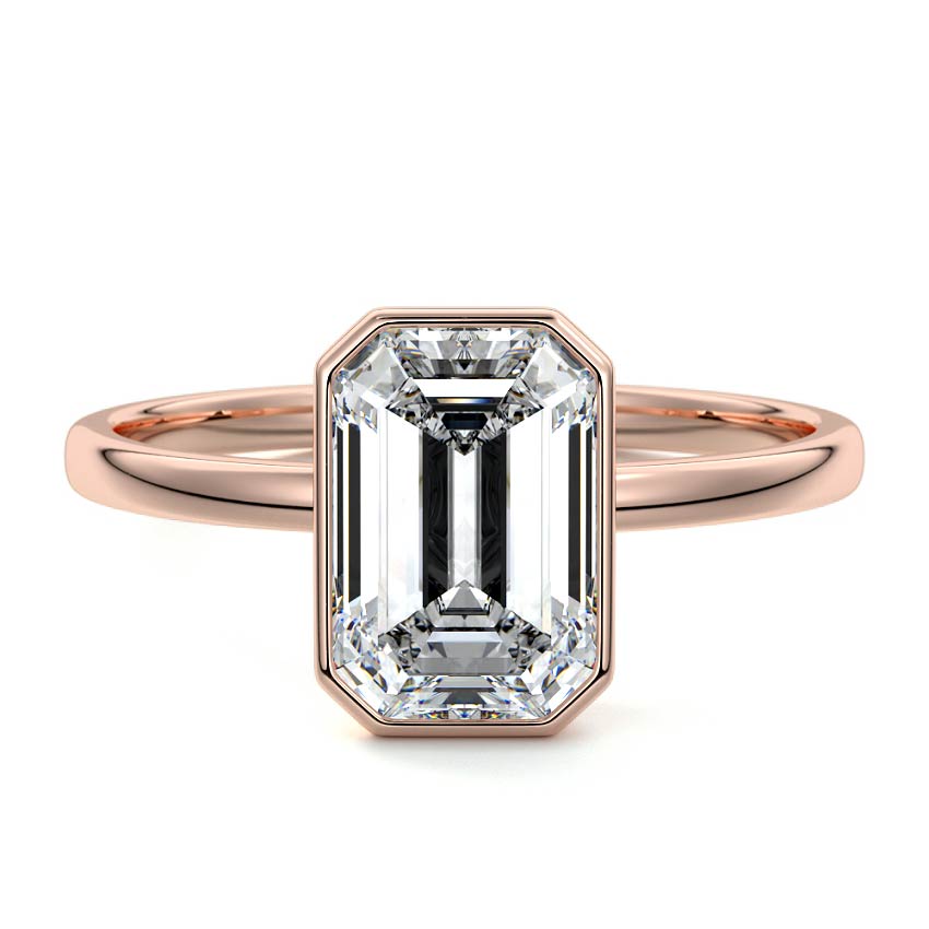 Bezel set emerald cut engagement ring in rose gold with lab-grown diamond