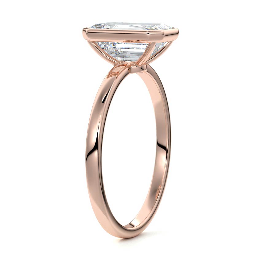 Bezel set emerald cut engagement ring in rose gold with lab-grown diamond
