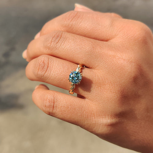 Genevieve Claire - Cyan Blue Round Cut Hidden Halo Ring With Twisted Rope Band