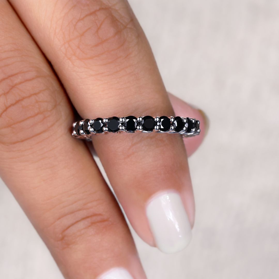 Moissanite eternity band featuring a round cut wedding band design.
