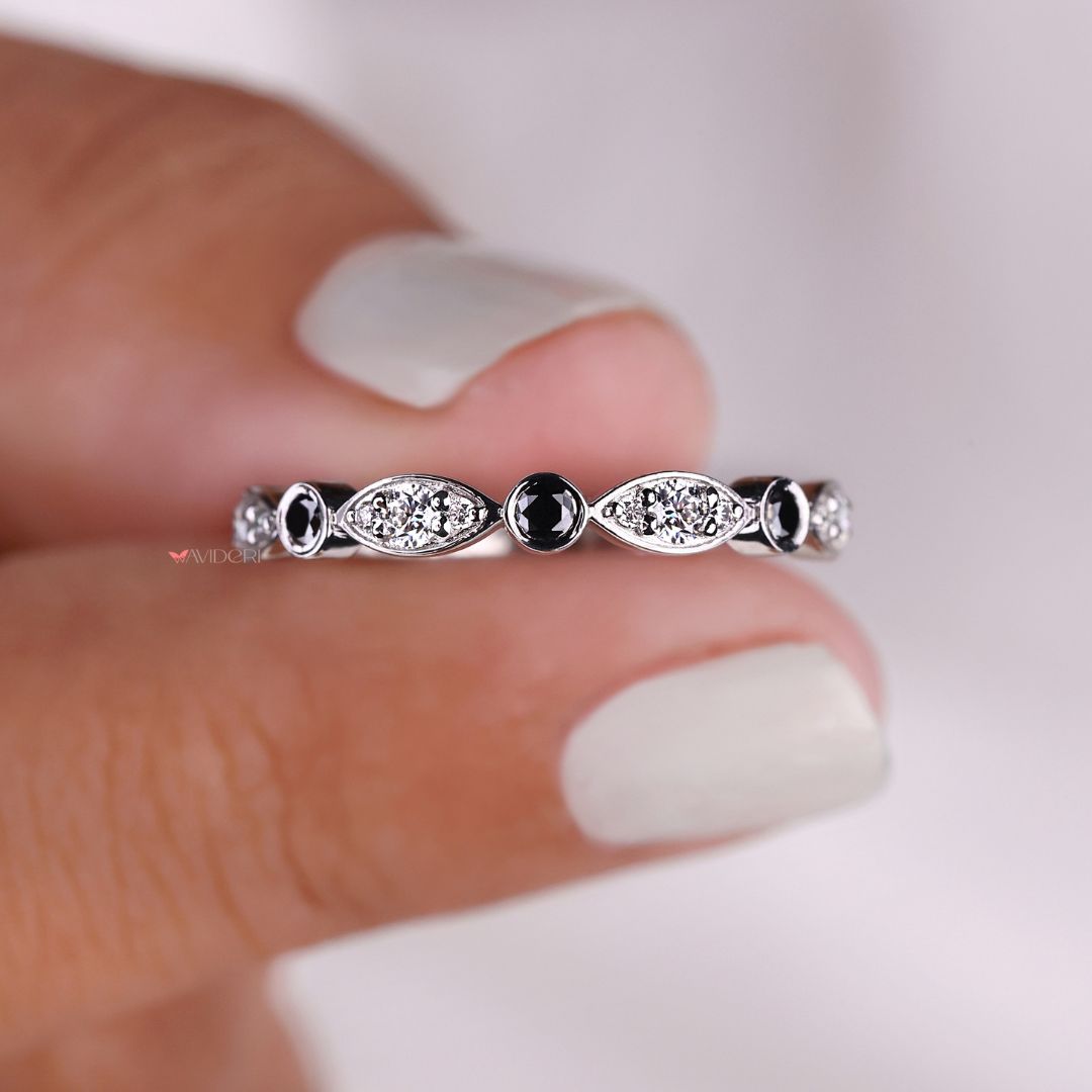 Black moissanite band features a striking contrast with radiant moissanite stones in a sleek design.
