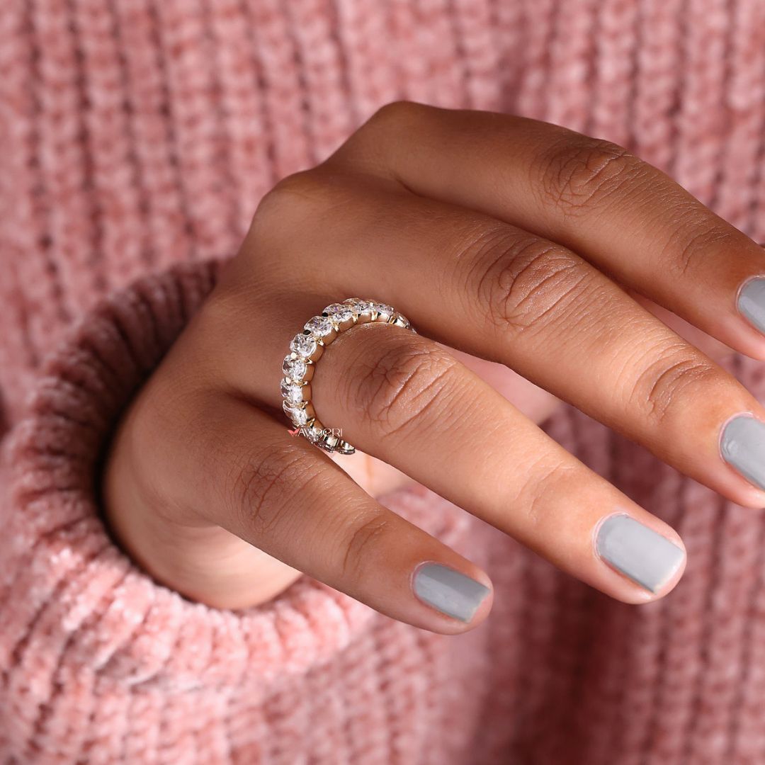 A Moissanite gold wedding band combines sparkle with warmth.
