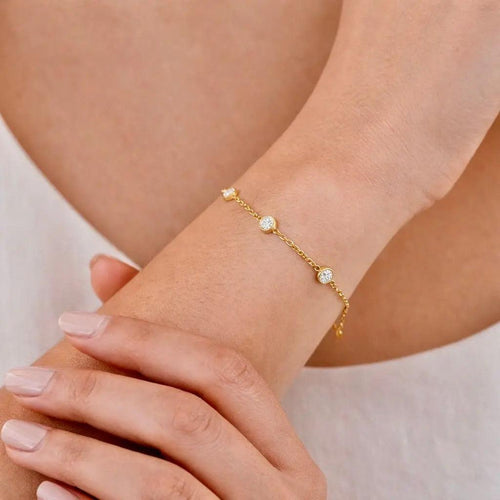 Budget-friendly 14K gold moissanite bracelet on model hand