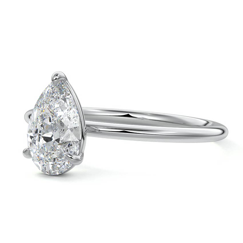 Pear-shaped diamond ring on a white background