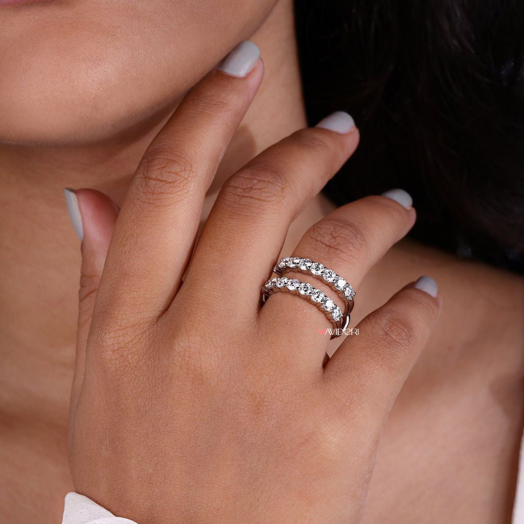 Moissanite wedding band features brilliant moissanite stones.