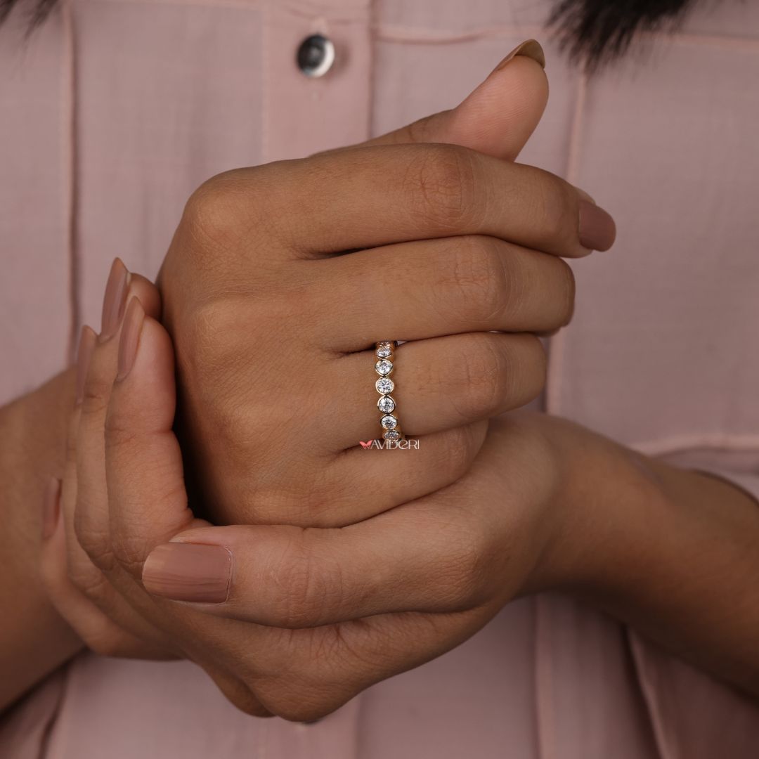 Round cut wedding band highlights clean curves with a glowing, classic profile.
