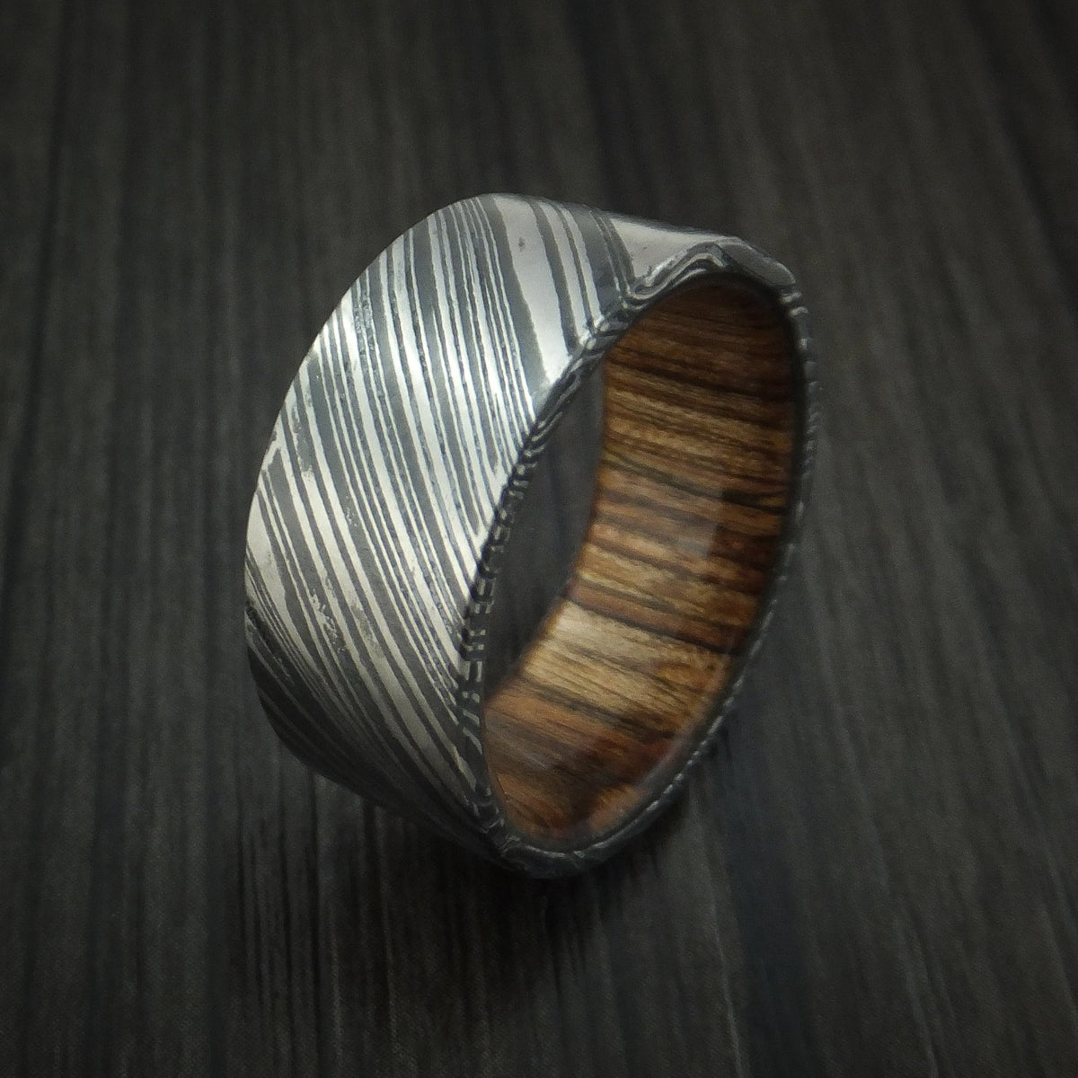 King George XI - Woodgrain Kuro Damascus Steel Men's Wedding Ring with Walnut Wood Hardwood Sleeve Wood Band - view 4 - Nura Lab