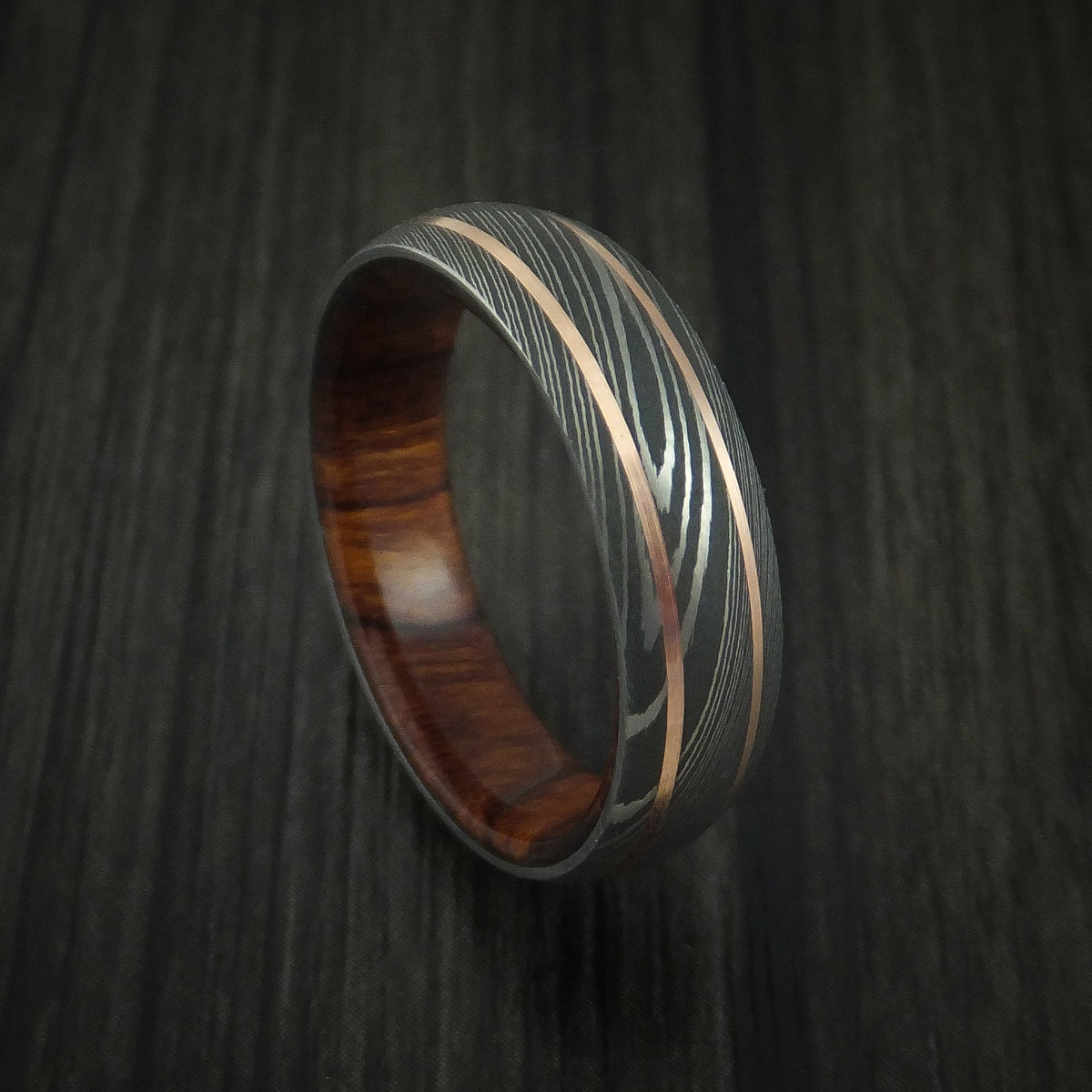 Stonehaven VIII - Damascus Steel and 14K Rose Gold Men's Wedding Ring with Desert Ironwood Burl Sleeve - Nura Lab
