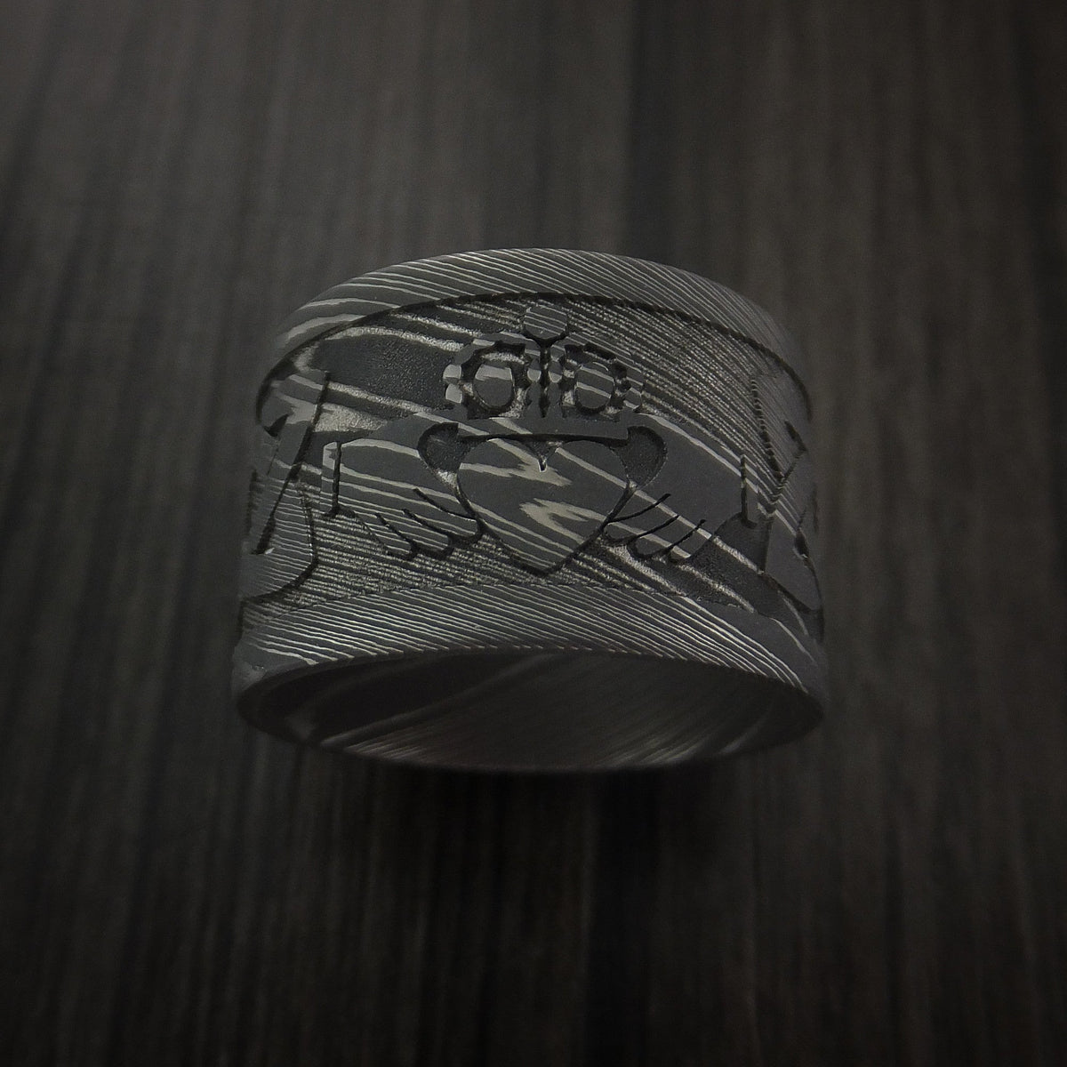 Fiord XI - Wide Damascus Steel Celtic Irish Claddagh Men's Wedding Ring Hands Clasping Heart Band Carved - view 2 - Nura Lab
