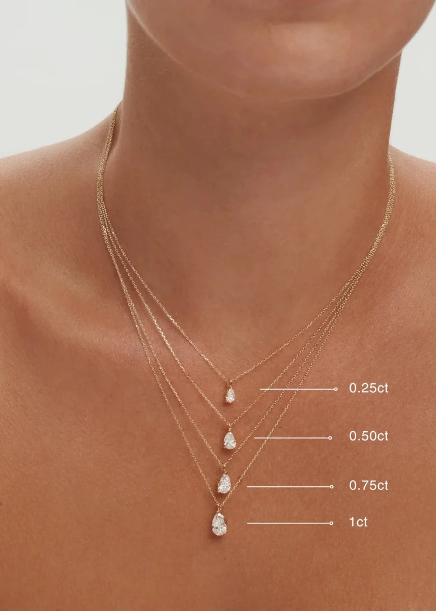 Gold necklace with diamond pendants on a person's neck, showing diamond carat weight.