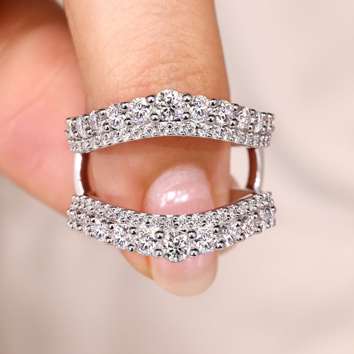 Enhancer wedding band with round cut moissanite.
