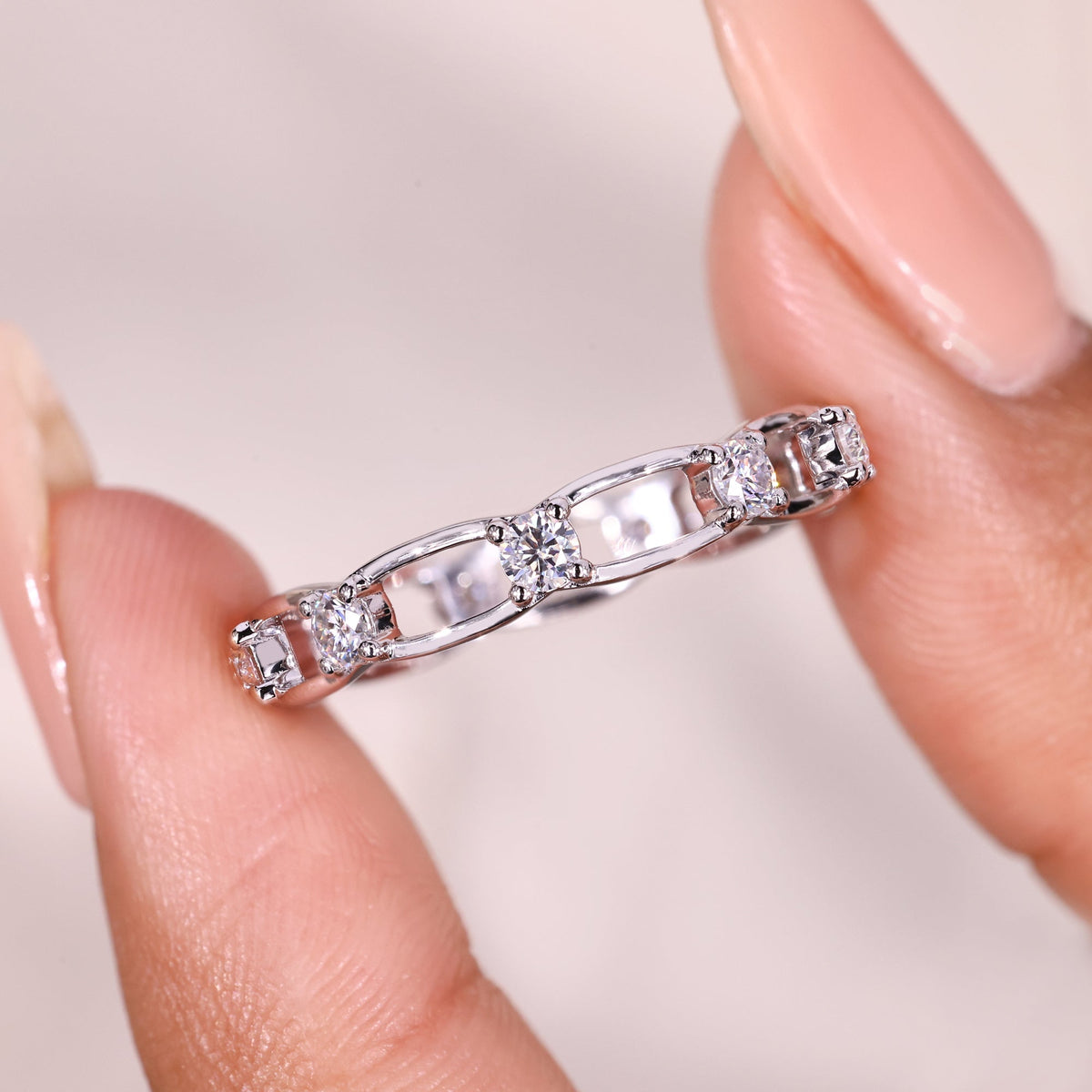 Round moissanite link style wedding band.
