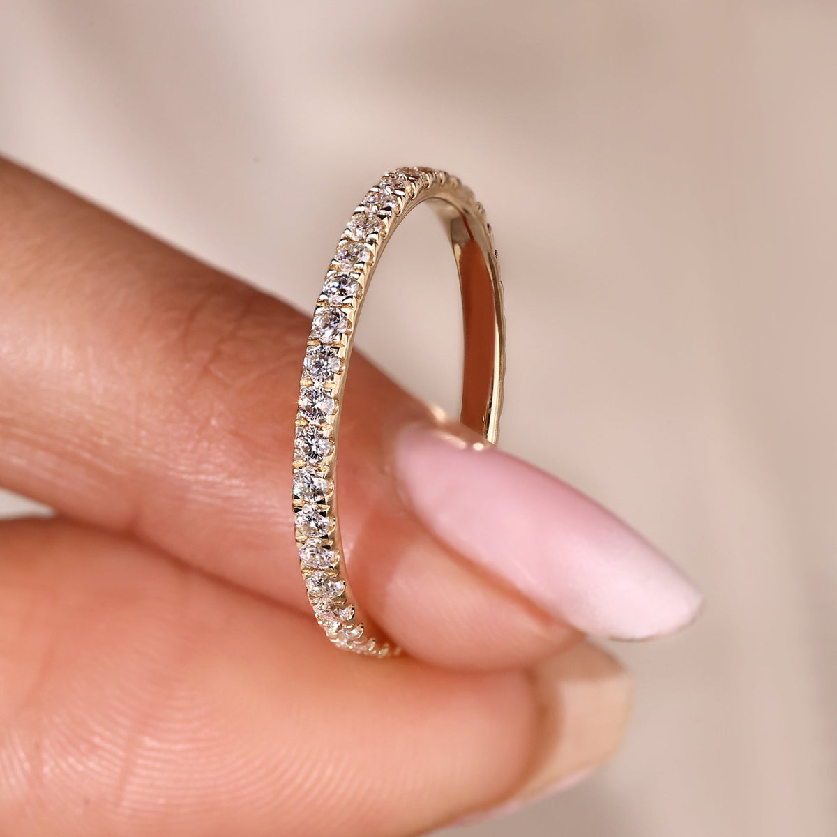 Stackable wedding ring offers layering versatility with modern style and shine.