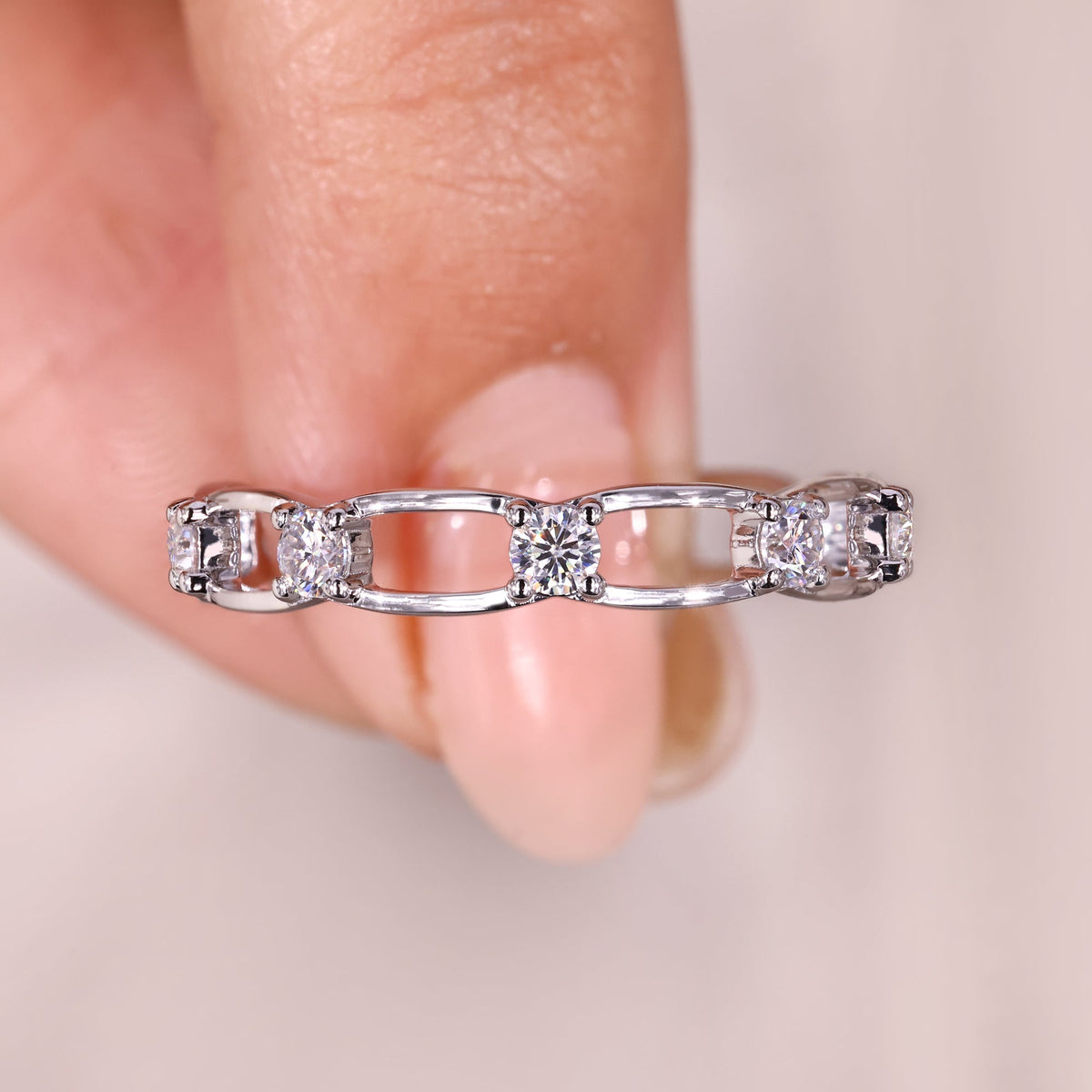 Round moissanite eternity wedding band with link style.

