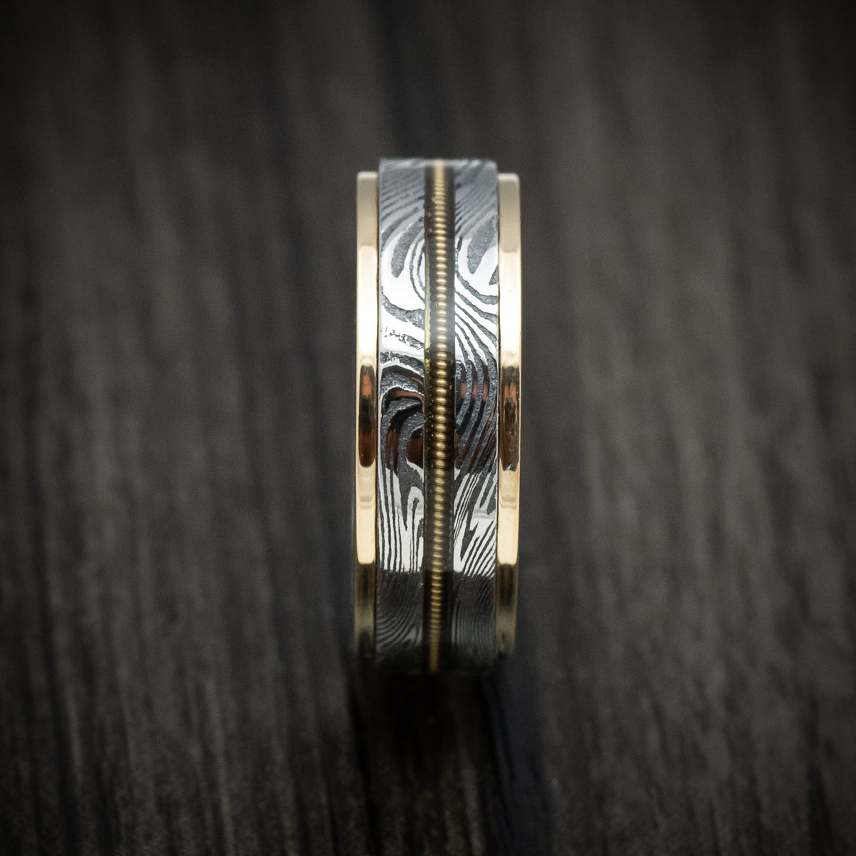 Augustus X - Sunset Kuro Damascus Steel and Guitar String Men's Wedding Ring with Gold Edges - view 3 - Nura Lab