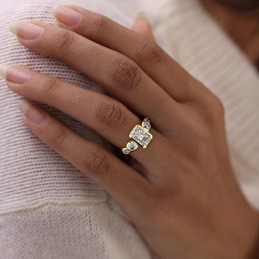 Evelina radiant bezel side stone lab grown diamond engagement ring in yellow gold