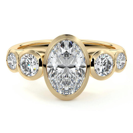 Evelina oval bezel side stone lab grown diamond engagement ring in yellow gold