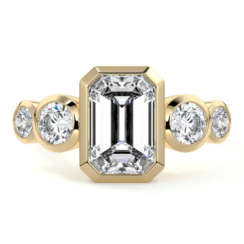 Evelina emerald cut bezel side stone lab grown diamond engagement ring in yellow gold