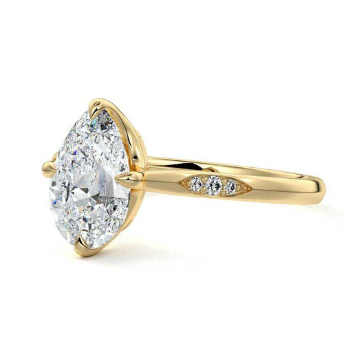Kaia pear flush set side stone lab grown diamond engagement ring in yellow gold