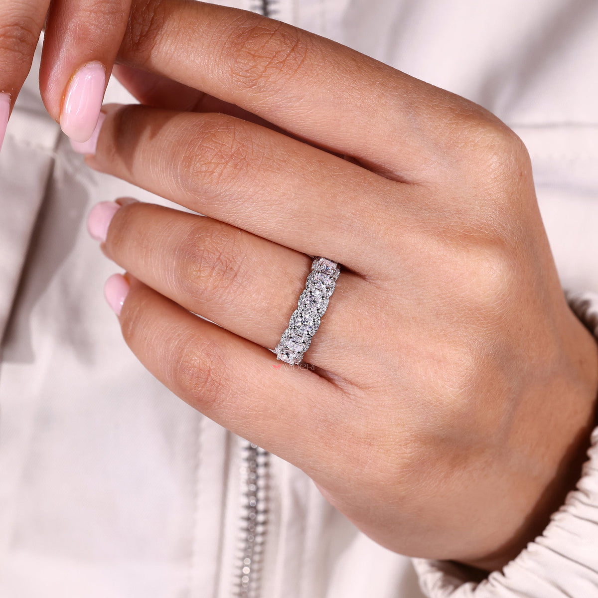 Moissanite wedding band in a half eternity style.