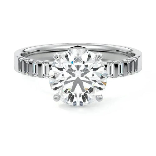 Round cut engagement ring with emerald cut side stones in 18K white gold by Nura Lab