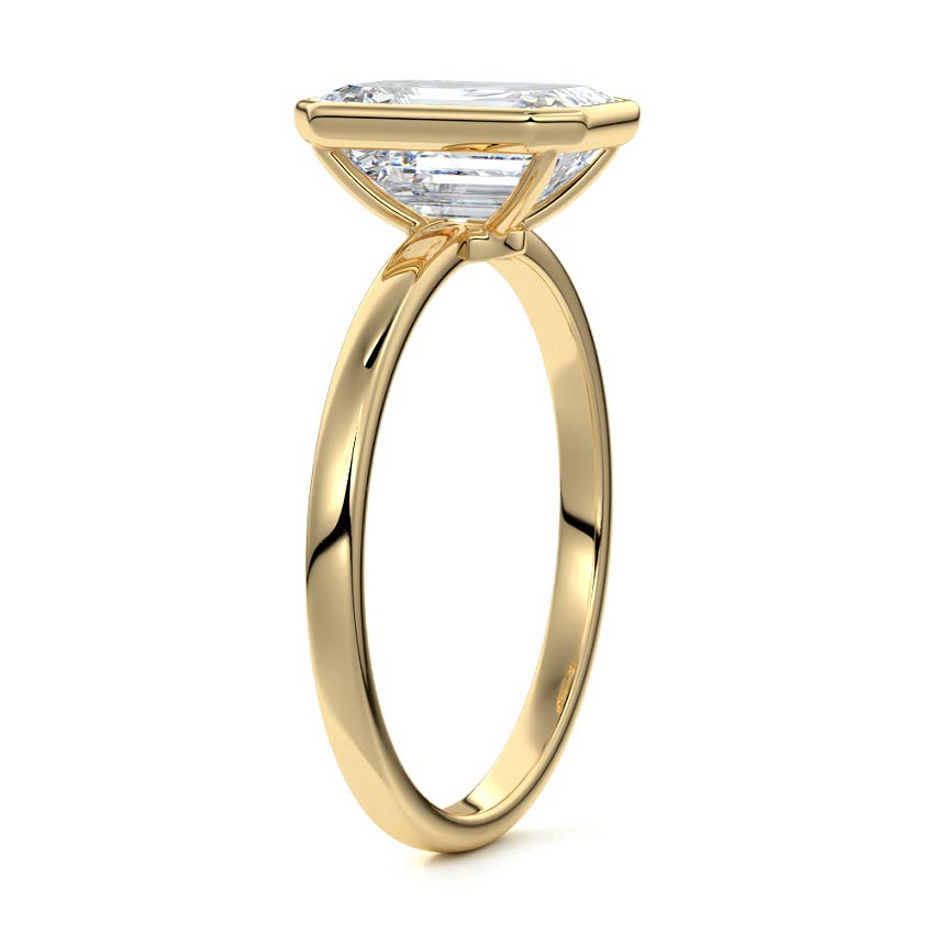 Bezel set emerald cut engagement ring in yellow gold with lab-grown diamond