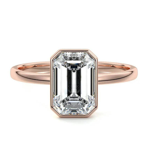 Bezel set emerald cut engagement ring in rose gold with lab-grown diamond