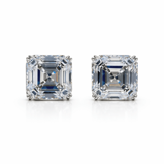 Two emerald-cut diamonds on a white background