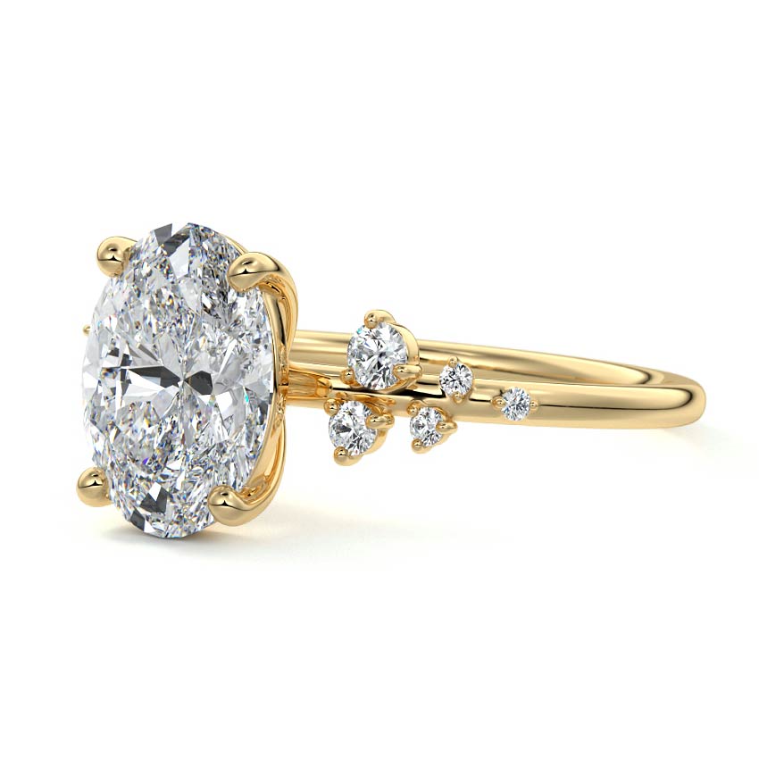 oval cut engagement ring with side stones yellow gold