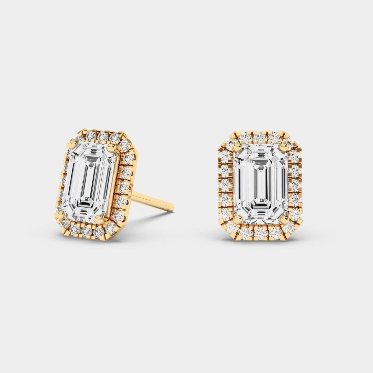 emerald cut halo stud earrings in yellow gold