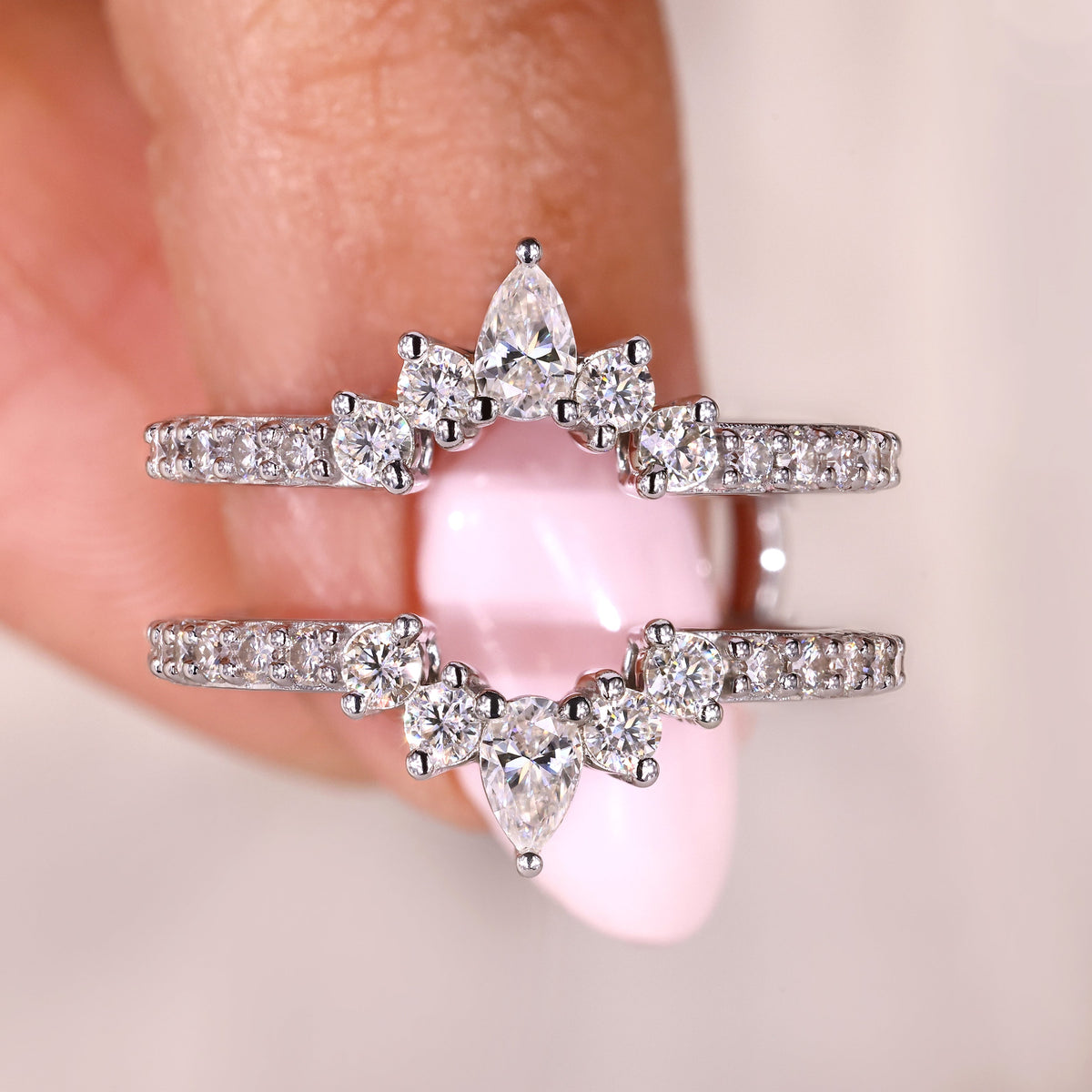 This pear moissanite wedding band has a unique, elegant design.
