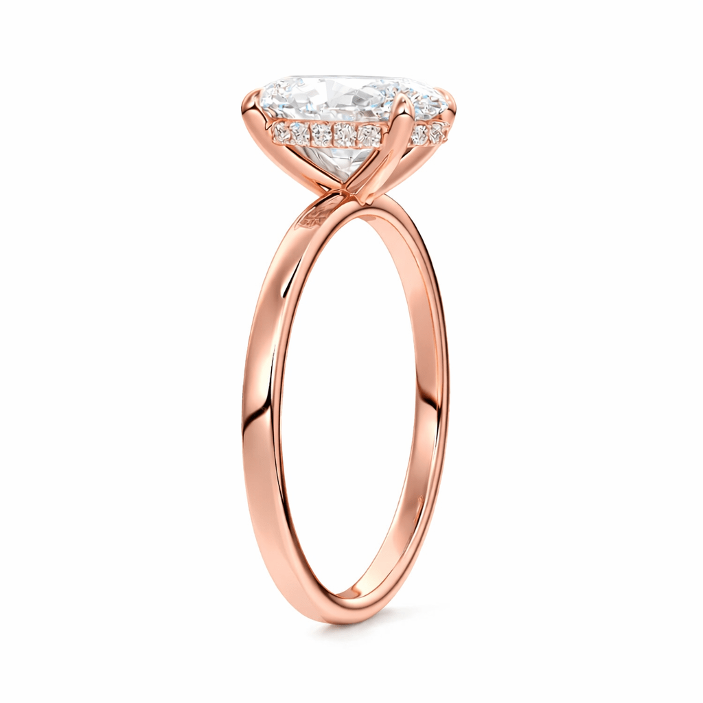 Rose gold ring with a large diamond and smaller diamonds on the band against a white background