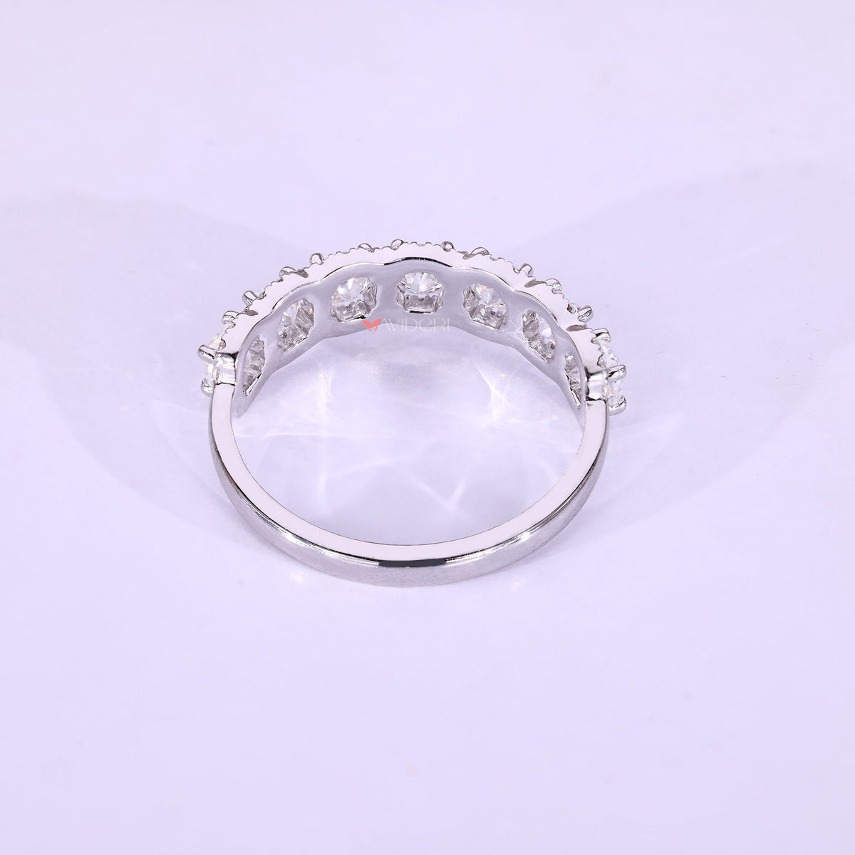 White gold wedding band with moissanite accents.